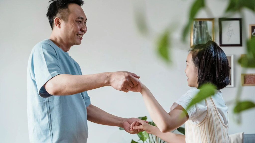 Father and daughter dancing together